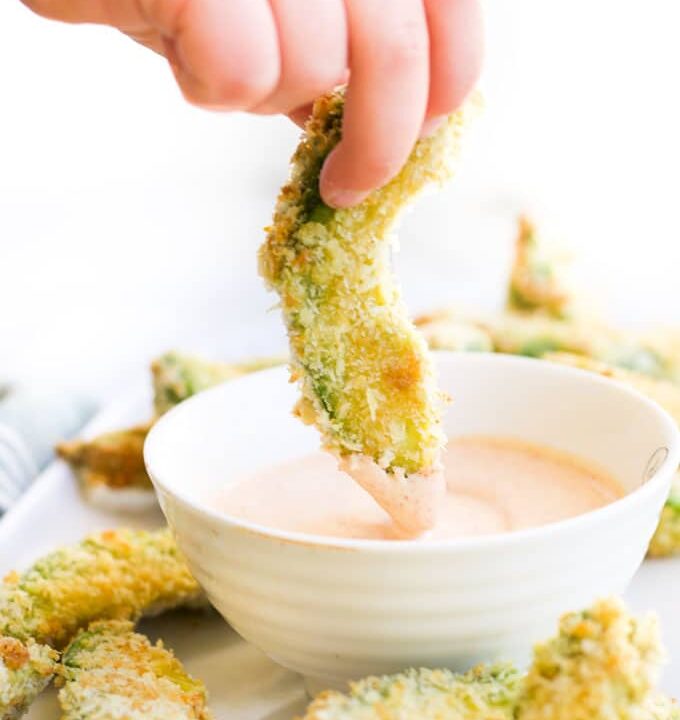 Child Dipping Avocado Fries into a Dip