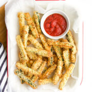 Courgette (Zucchini) Fried in Tray with Small Bowl of Pizza Sauce.