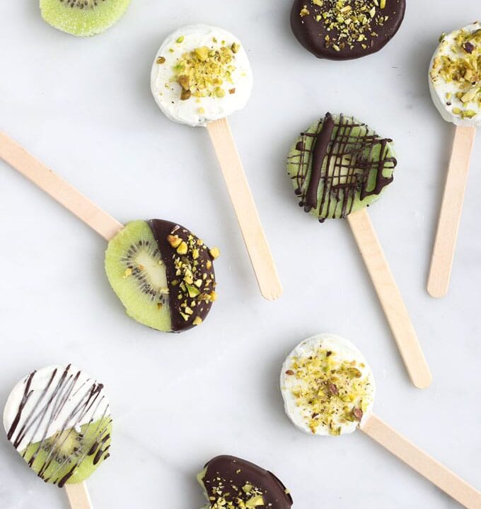 Frozen Kiwi Pops Coated in Yoghurt and Chocolate with Crushed Pistachio