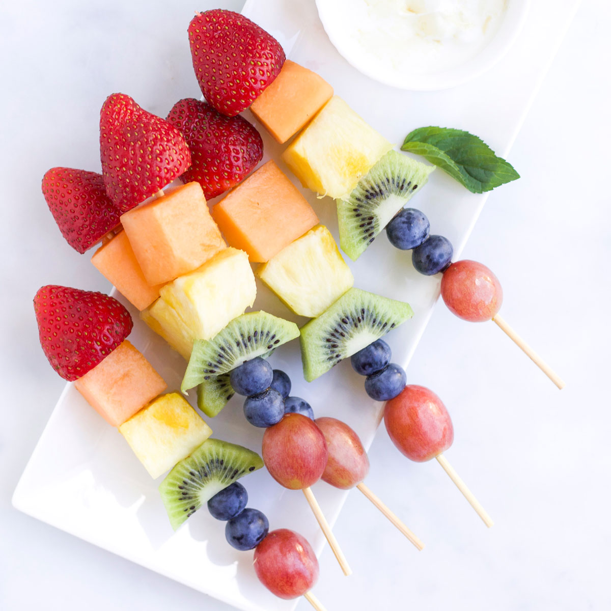 Fruit Kebabs on Tray with Dip to Side.