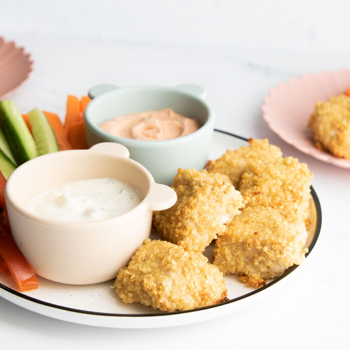 Quinoa Crusted Chicken Nuggets on Plate With Dips and Veggie Sticks.