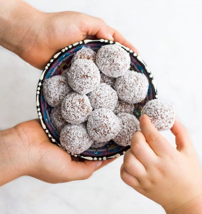 Child Grabbing a Sweet Potato Truffle from Bowl
